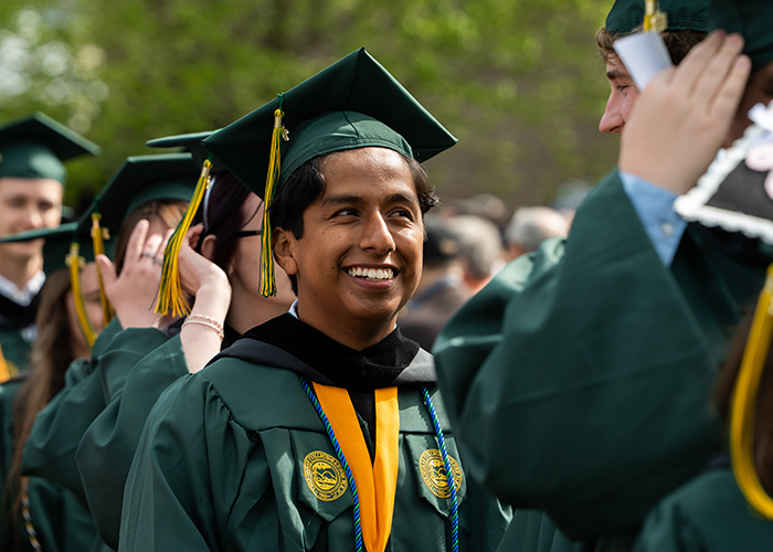 A graduate smiles during the processional.