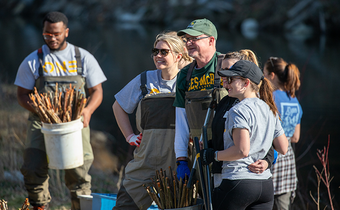 A group of volunteers pose at a volunteer site during Mountain Day of Service