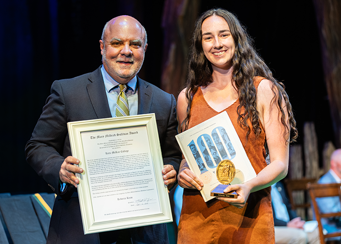 Rebecca Ryan smiles with President King while holding her award.