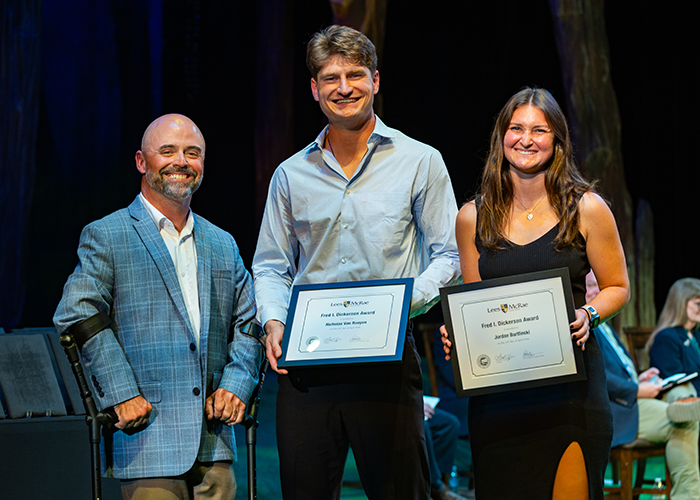Jordan Bartlinksi and Nicholas Van Rooyen smile with Josh Pate while holding their awards.