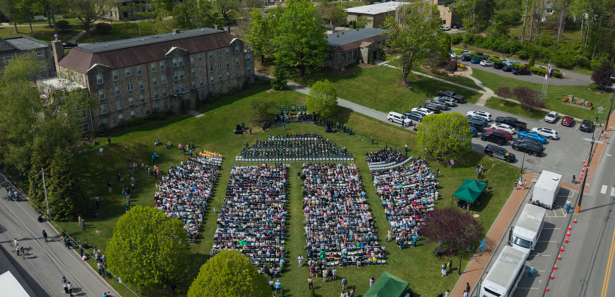 Aerial image of Commencement showing seats filled with graduates and guests.