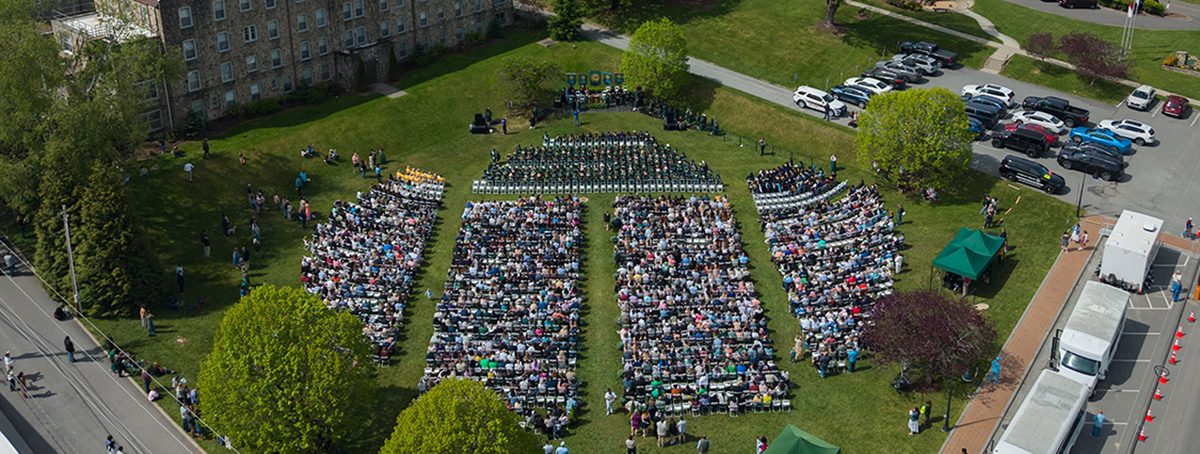 Aerial image of Commencement showing seats filled with graduates and guests.